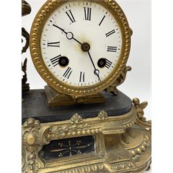 Late 19th century French gilt metal figural mantel clock, the circular enamel Roman dial beside figure of a girl holding a bird and cage, eight day movement by ‘Japy Freres’ striking the hours and half on bell, on black slate platform, ornate floral and cartouche moulded base