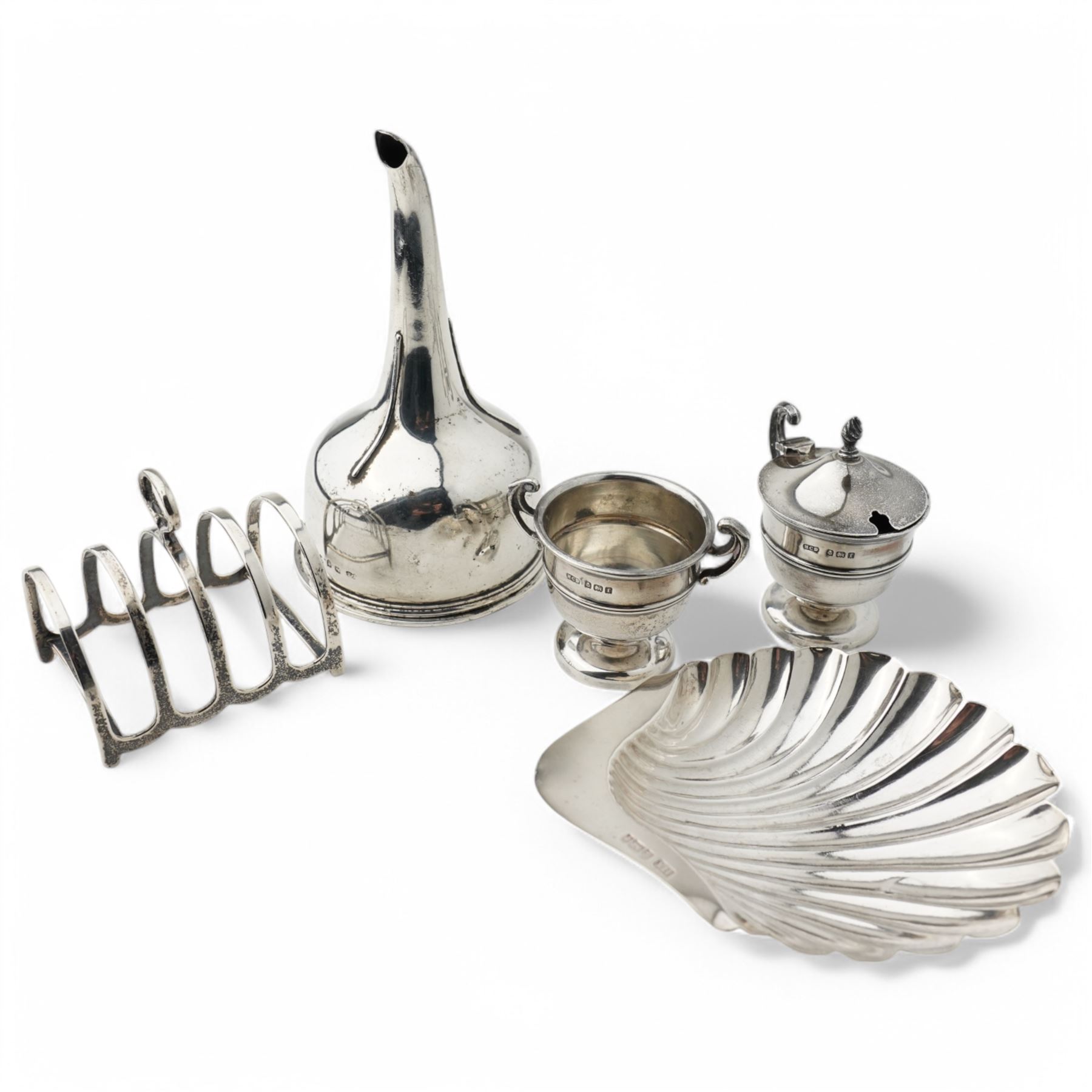 George III silver wine funnel London 1818 Maker William Bateman I, small silver four division toast rack, shell butter dish and two condiments 