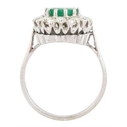 White gold emerald and diamond cluster ring, single oval cut emerald of approx 1.35 carat, surrounded by twelve brilliant cut diamonds, stamped 18ct, total diamond weight approx 0.85 carat