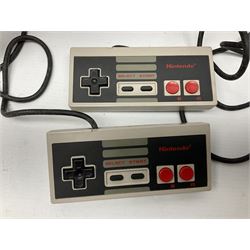 Nintendo Entertainment System (1985) console with two controllers, accessories and instruction booklet. NES Games ‘Duck Hunt’ with Nintendo Zapper gun, ‘Pinball’ and ‘Super Mario Bros.’, all with original sleeves and instruction booklets. NES game ‘Super Mario Bros. 2’ cartridge only