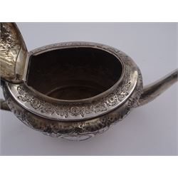 George III silver teapot, of oval form, with embossed foliate, floral and scroll decoration and engraved central cartouche, with acanthus capped C handle with ivory insulators, hallmarked John Emes, London 1807 This item has been registered for sale under Section 10 of the APHA Ivory Act
