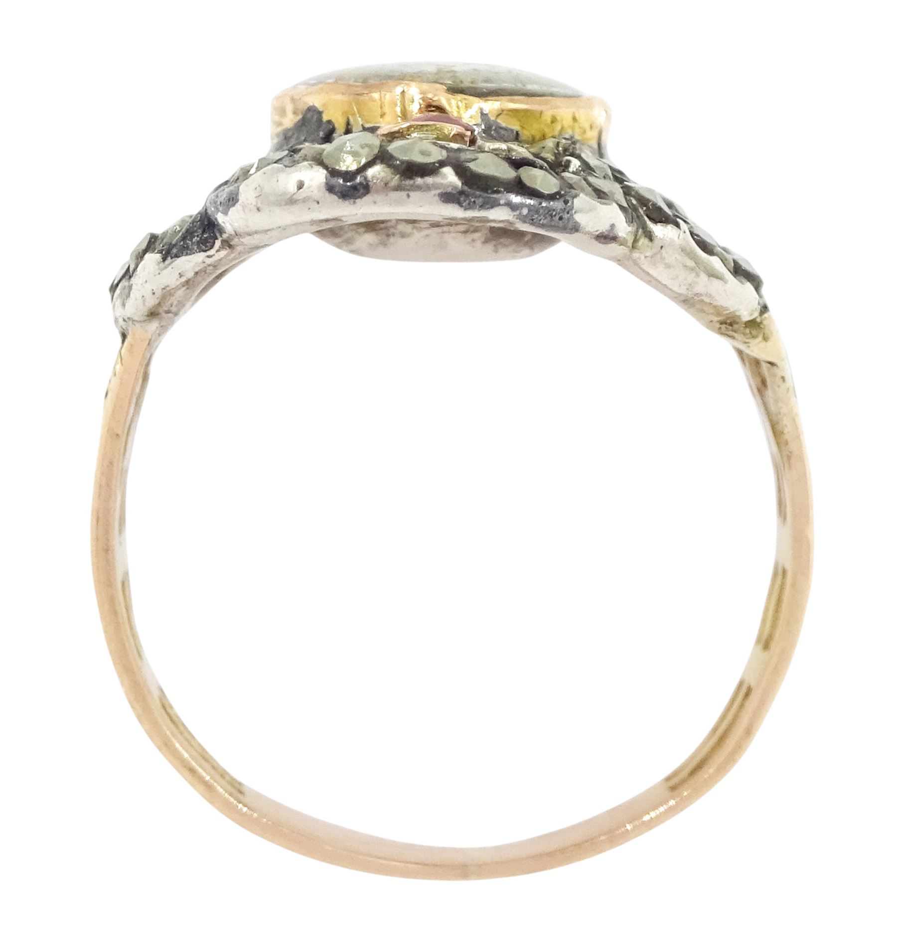 19th century gold and silver marcasite portrait ring, set with an oval miniature of a woman on ivory, under a glazed panel, with a marcasite and red stone set crossover surround, with pierced gold shoulders and reeded shank. This lot has been registered for sale under Section 10 of the APHA Ivory Act