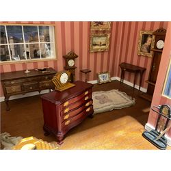 Good quality late 20th century dolls house by M. James dated 1995 in the form of a Beverley East Yorkshire Antique Shop called 'North Bar Antiques'; single-storey single-roomed shop with textured brick walls and flat roof, fully glazed hinged front with recessed hinged customer door and central window to the rear; comprehensively furnished with chests of drawers, pedestal desk, breakfast table, lowboy, two longcase clocks, delft rack with ceramics, occasional tables, pictures, Regency style mirror and collectibles; decorated walls with coving and picture rail and simulated floorboarding; wired for electric lighting; maker's plaque W61cm H42.5cm D41.5cm