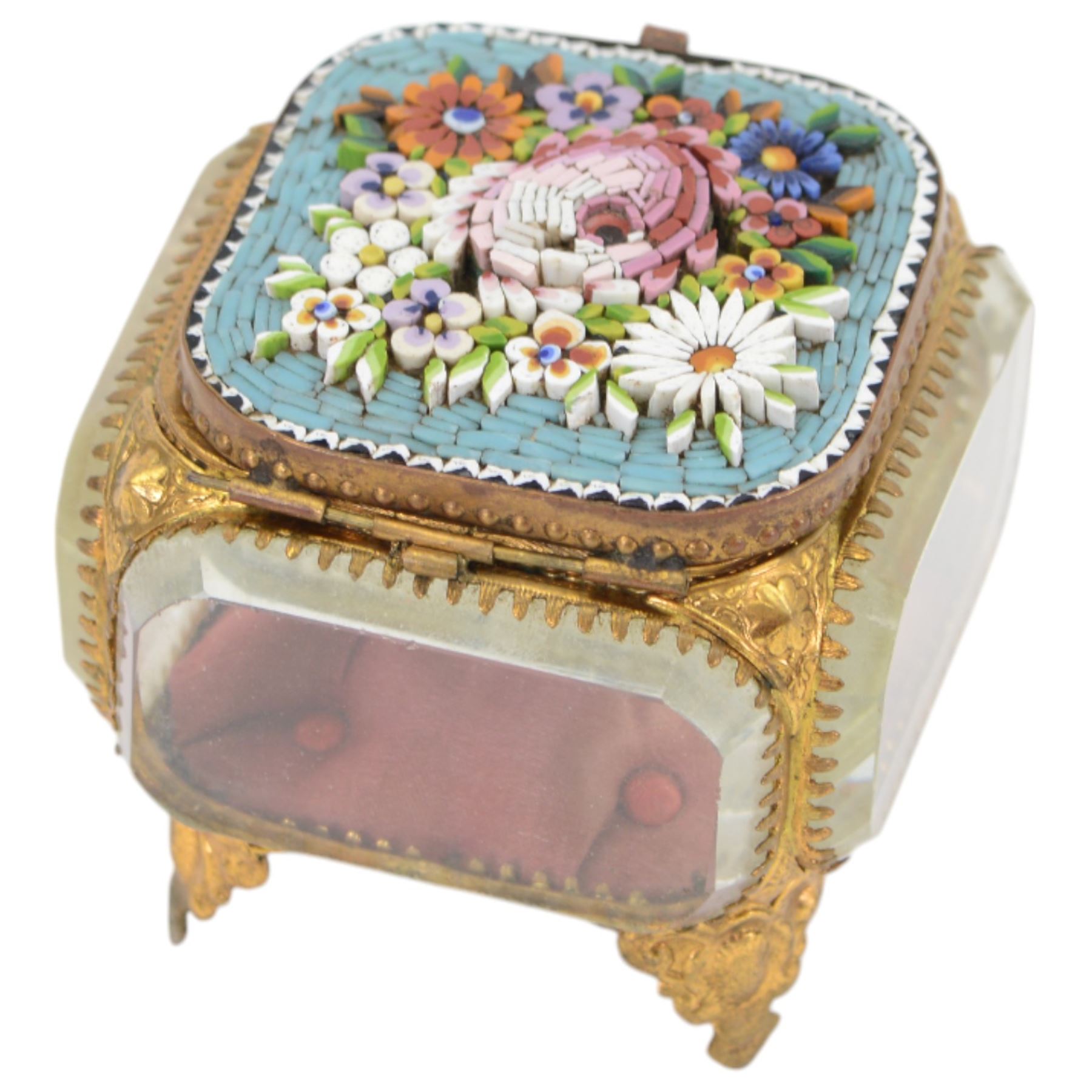
Two Micro mosaic jewellery caskets with bevelled glass sides, the hinged lid decorated with raised flowers upon a blue ground, raised upon pierced gilt feet, largest H7cm 