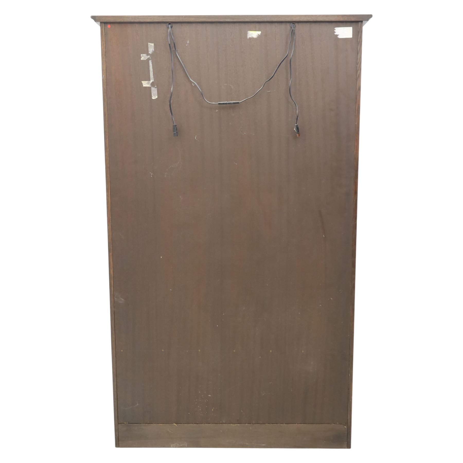 Mid 20th century oak display cabinet, the moulded rectangular cornice above a pair of leaded glazed doors with diamond lattice glazing, enclosing adjustable shelving, the lower section fitted with four short drawers with brass ring handles, flanked by chamfered uprights with carved leaf detail