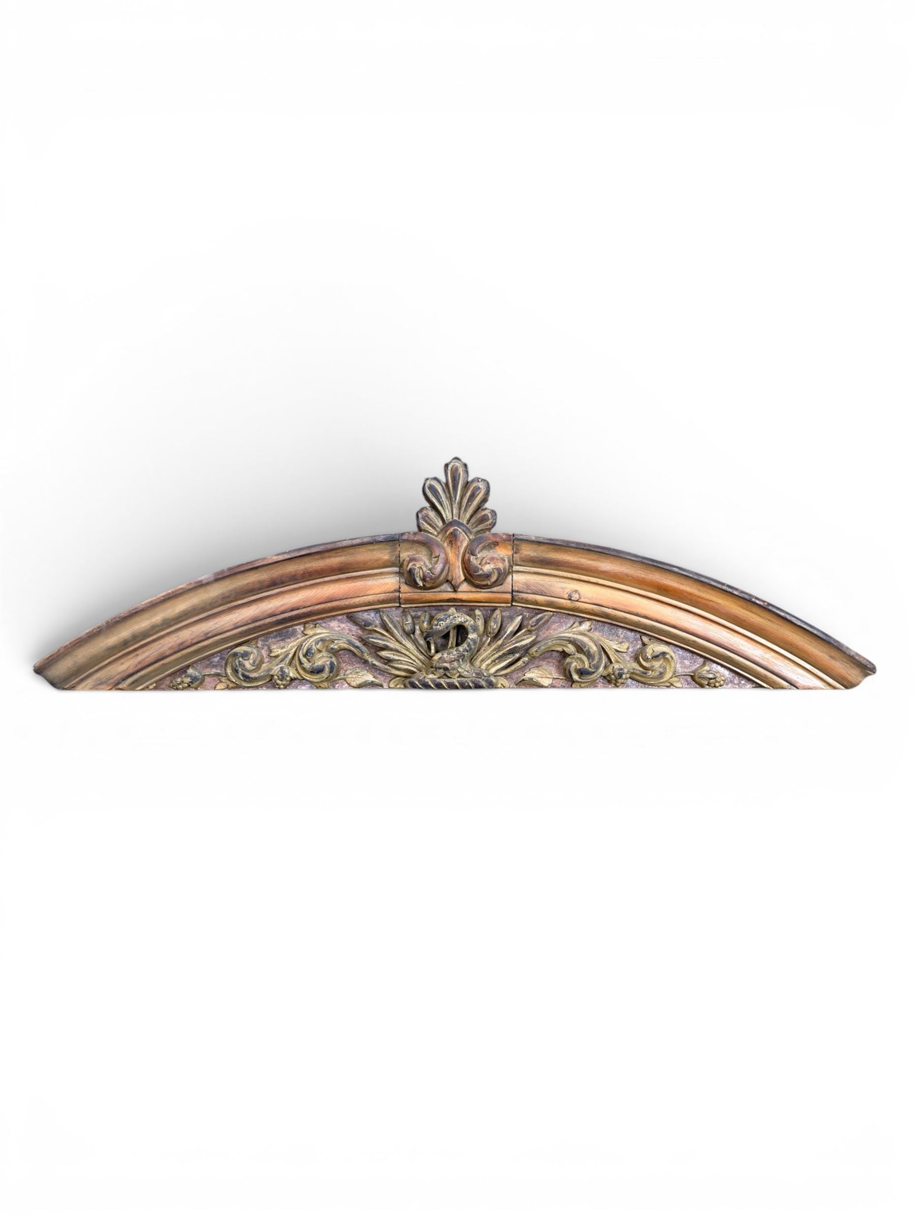 19th century carved pine architectural pediment, detailing floral swags with berries and central serpentine snake head 