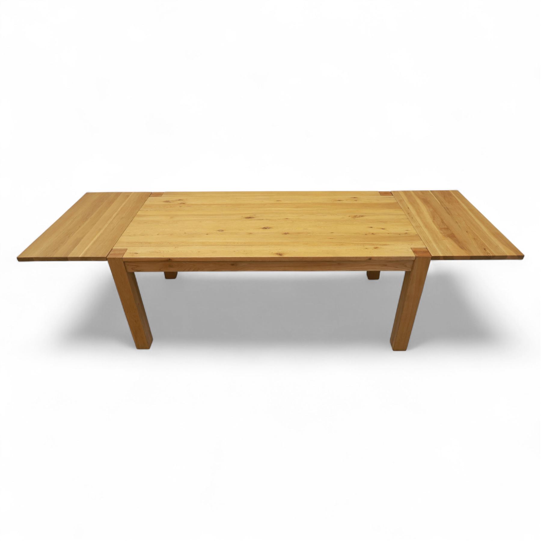 Modern oak dining table, rectangular form with detachable twin leaf extensions, supported on straight square-section legs (Extends to 280cm) 