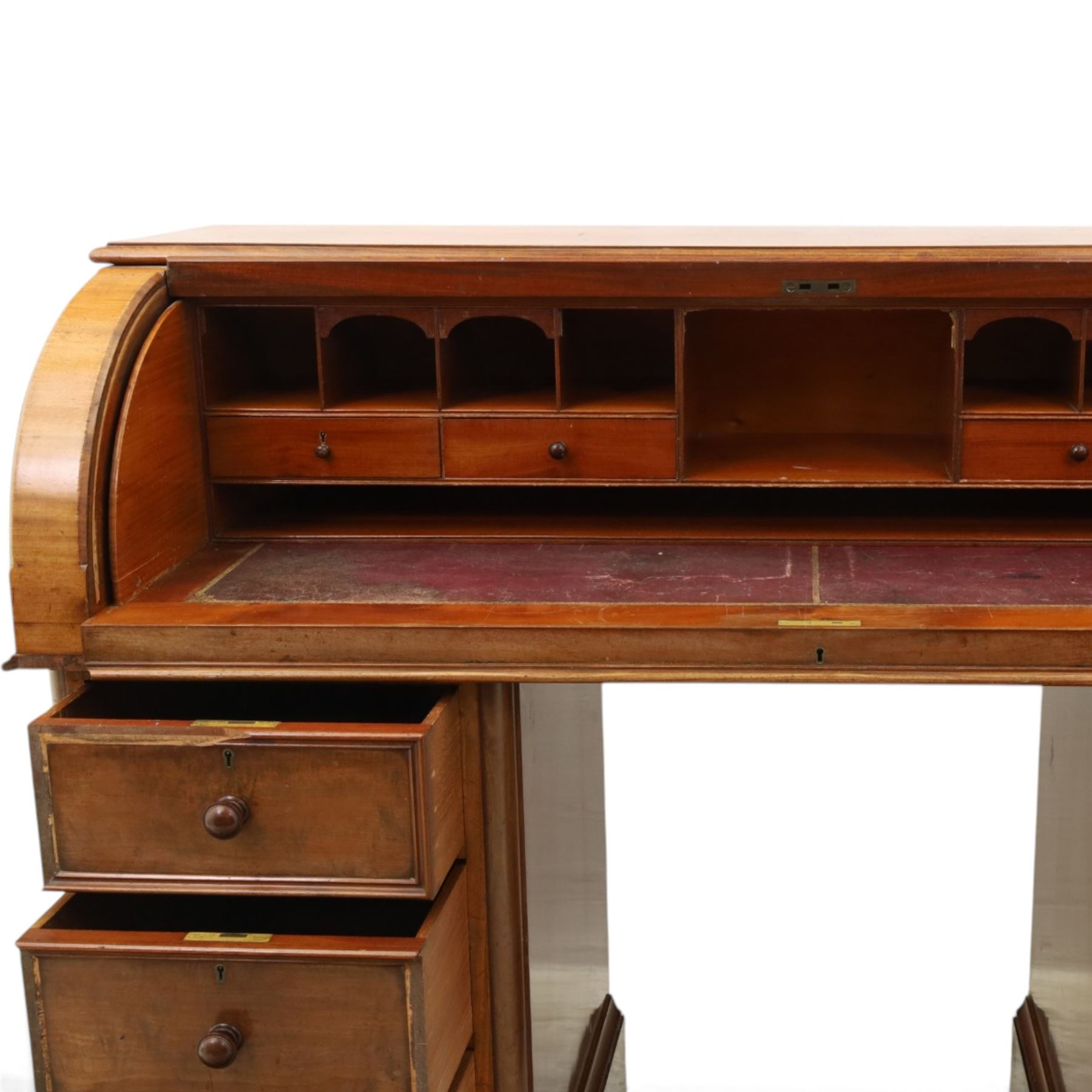 Victorian mahogany twin pedestal cylinder desk, with roll top with fitted interior and with leather writing slide, raised on pedestals with three graduating drawers, raised on a plinth base with castors