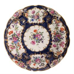 Pair of Worcester junket dishes, c1770, painted with panels of flowers on a blue scale ground within richly gilt rococo style borders and scalloped rim, hatched square mark to base, D24.5cm (2)
Notes: label suggests provenance relating to the Brownlow family of Belton House.