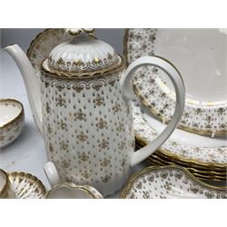 Modern Spode coffee and dinner wares for six place settings, decorated in the Fleur De Lys Gold pattern, comprising dinner plates, dishes, side plates, one handled fan shaped serving dish, coffee pot, coffee cans, saucers, open sucrier and cream jug, with red and black printed marks beneath 