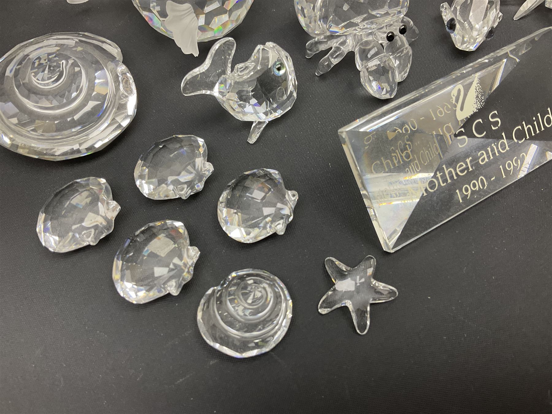 Nineteen Swarovski Crystal sea creatures, to include dolphins, seals, puffer fish, octopus, crabs, together with a quantity Swarovski Crystal shells 