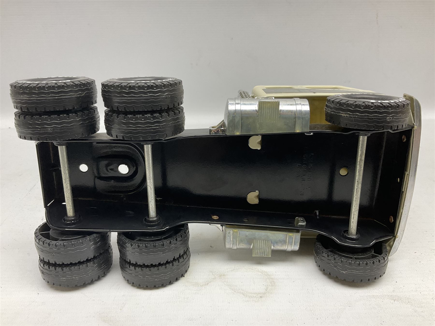American Nylint large scale tin-plate car transporter L59cm carrying a Testor Toys plastic car; Tonka tin-plate mobile crane; boxed Sarony Cigarettes tin-plate roulette game with rules; and Japanese style tin-plate box, the lid inset with a revolving poker dice game (4)