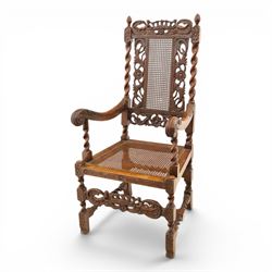 Late Victorian Jacobean Revival oak armchair, the caned back within a pierced and carved foliate frame surmounted by acorn finials, carved scroll arm supports, caned seat, on barley twist supports united by stretchers and carved front rail