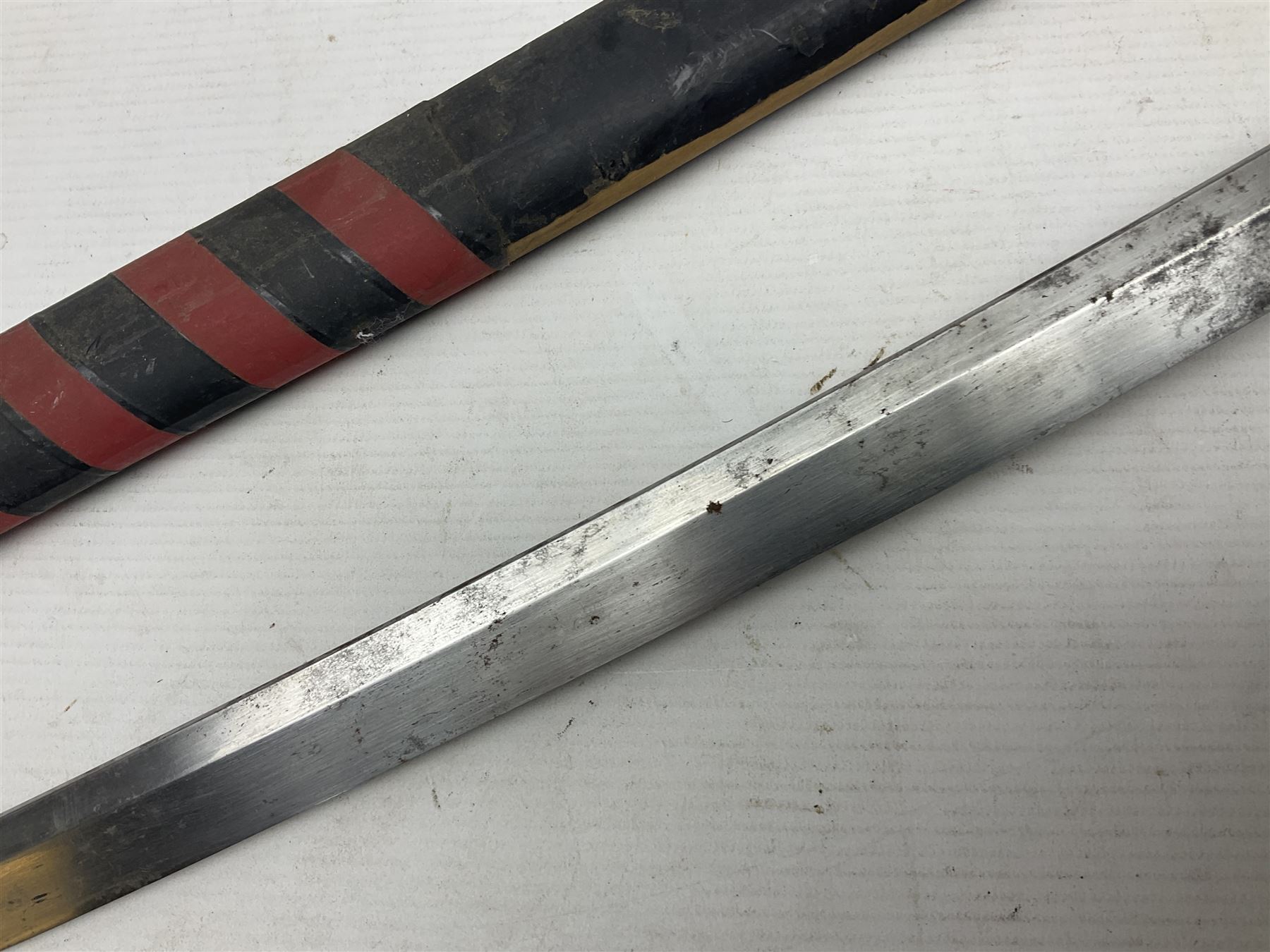 Good quality Japanese sword blade with later WWII fittings and scabbard  - 67.5cm slightly curving blade with unmarked tang, plain iron tsuba and lacquered grip with copper mounts; in lacquered wooden scabbard with tape bound tip L94cm overall