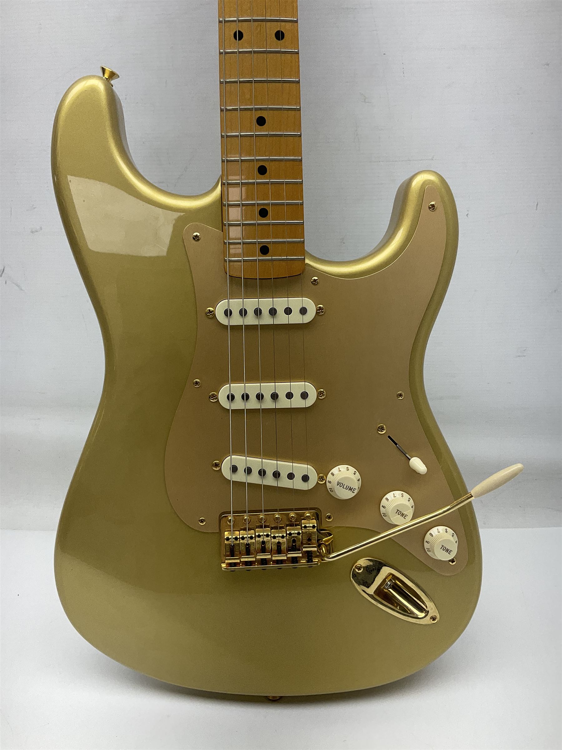 Fender Stratocaster 50th Anniversary 2004 metallic gold electric guitar; serial no.MZ4116369; L98cm; in Spider fitted case with owners manual and other paperwork, strap and belt buckle etc