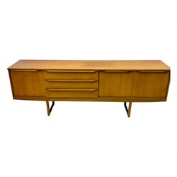 Mid-20th century teak sideboard, fitted with a fall-front cupboard, three drawers including a green baize-lined cutlery drawer, and a double cupboard, with integrated handles, on sleigh supports