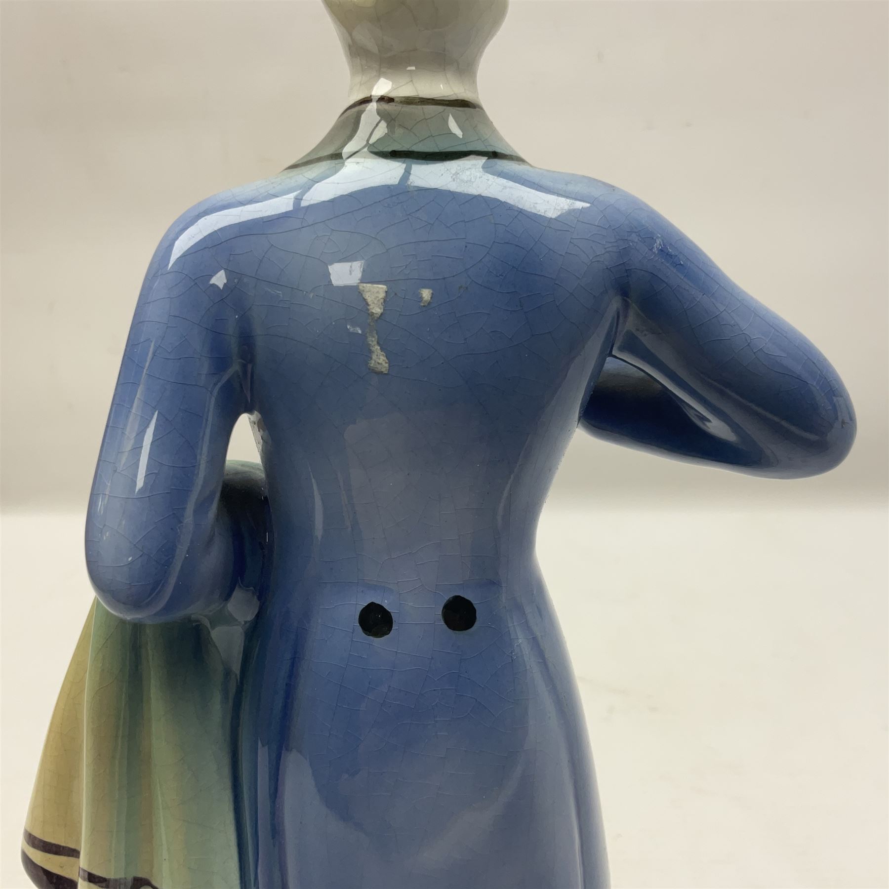 Goldscheider figure, modeled as a gentleman with flowers, upon a circular base, with printed mark beneath, H25cm