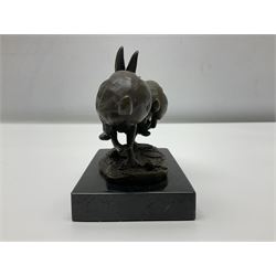 Bronze figure group, modelled as two hares in chase, upon a naturalistic base signed Nick and with foundry mark, raised upon a rectangular marble base, overall H12cm. 
