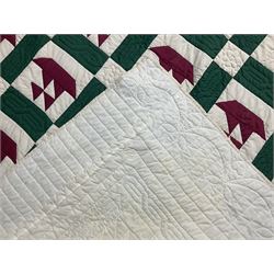 20th century quilt, with repetitive ship design to the centre within a cream red and green boarder, 227cm x 222cm