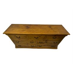 Pine dresser, rectangular top above seven drawers, with two smaller drawers over five larger drawers, all fitted with cast metal handles, raised on a shaped plinth base

