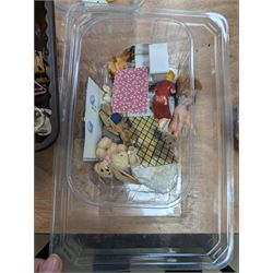 Two modern three storey dolls houses, each painted green with decorated interiors, both upon a single white wooden base, together with a large collection of dolls house furniture, accessories and figures 