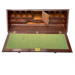Early 19th century figured mahogany bureau bookcase, projecting splay moulded cornice over three adjustable shelves enclosed by two glazed doors, fall front revealing pigeonholes, cupboard and drawers, pull-out strays with scroll carved terminals, double cupboard with two panelled doors, on turned feet 