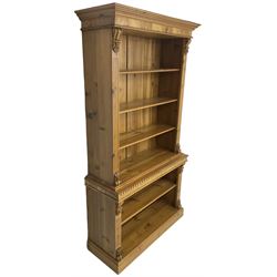 Polished pine and elm bookcase, projecting moulded cornice over three shelves and fluted uprights, leaf and S-scroll carved brackets, the lower section with gadroon moulded top fitted with single shelf, matching fluted uprights and brackets, on plinth base 