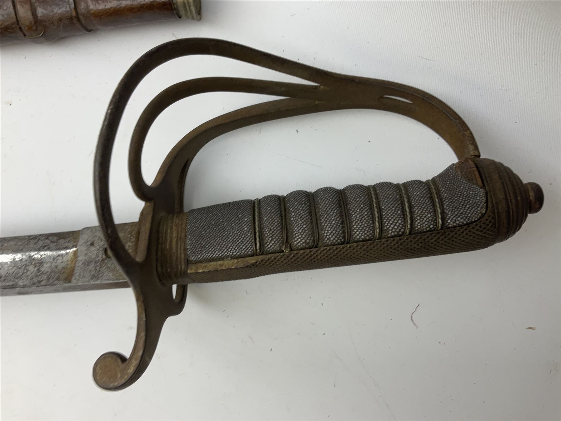 Victorian artillery officer's sword, the 90cm fullered steel blade by E. Thurkle Denmark Street Soho London decorated with Victoria cypher, Regimental crest and 'Royal Artillery', three-bar hilt with stepped pommel and wire-bound fish skin grip; in leather covered scabbard L107cm overall