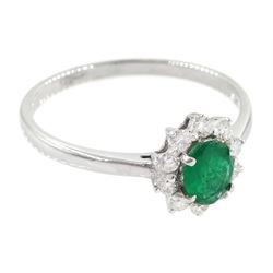 18ct white gold oval cut emerald and round brilliant cut diamond cluster ring, stamped 750