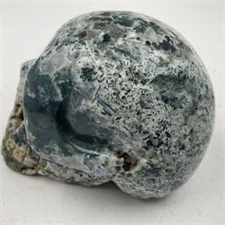 Carving of a skull in moss agate, H9cm, L12cm 