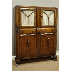  Early 20th century carved oak cabinet enclosed by four doors with two centre drawers, W110cm, D36cm, H140cm  
