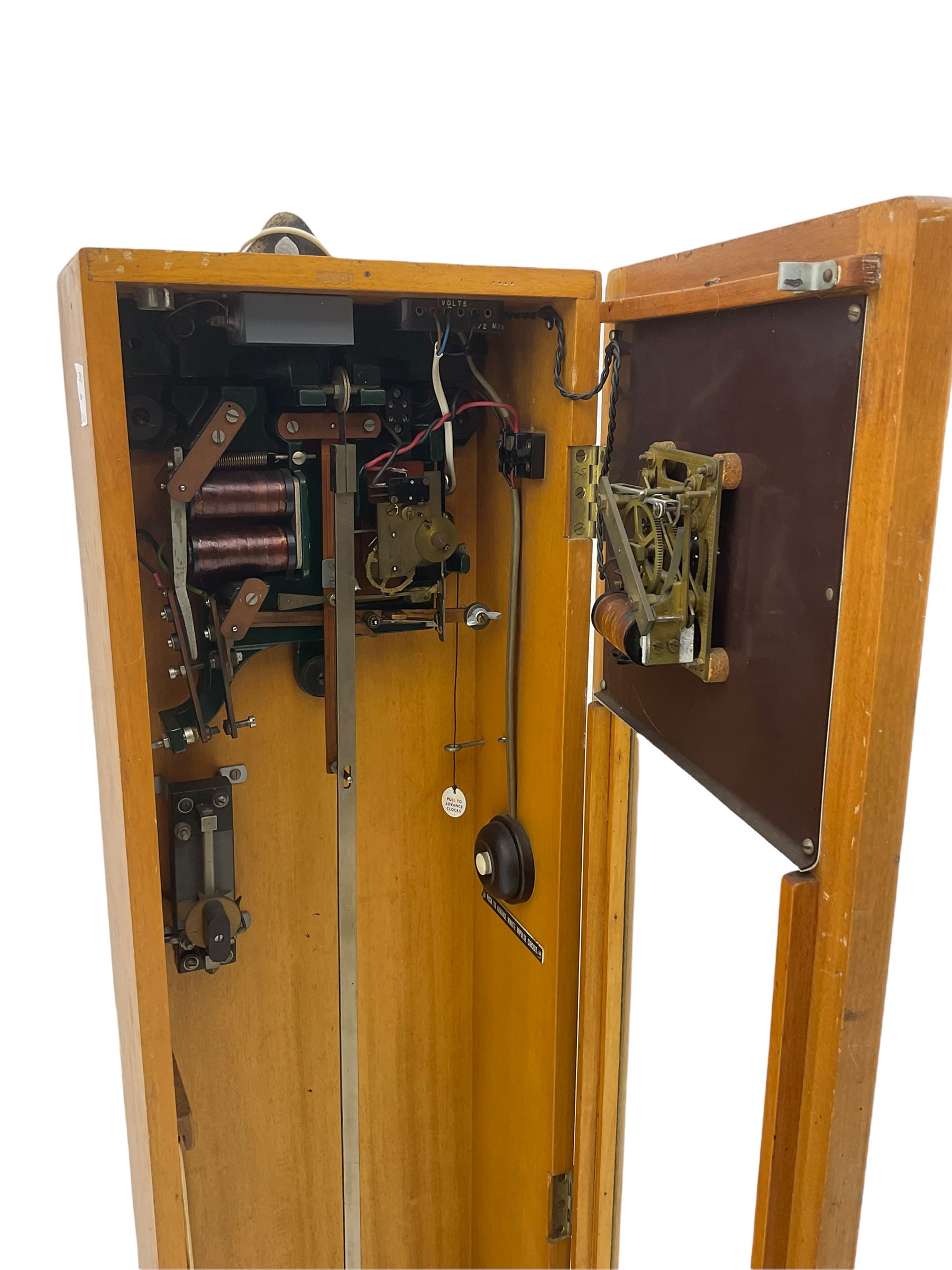 A mid-20th century Gent of Leicester(Blick Electric) Pulsynetic Master Clock in a full length glazed wooden case, with a square white dial with Arabic numerals, minute markers and baton hands, with pendulum and a record card dating from the 1970’s. 
This master clock would have been wired to send time signals to other slave dials in a large building, frequently used in hospitals, schools and factories during the 20th century
With a second electrical movement housed in a glazed square cabinet.


