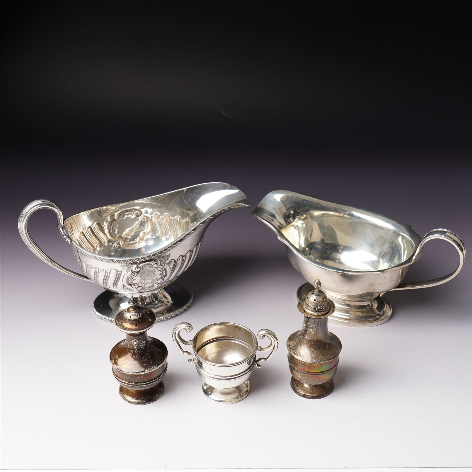 Victorian silver sauce boat engraved with a monogram Sheffield 1892 Maker John Round  & Son Ltd, another with crimped rim Birmingham 1912 Maker Elkington & Co, two silver pepperettes and a small silver challenge cup