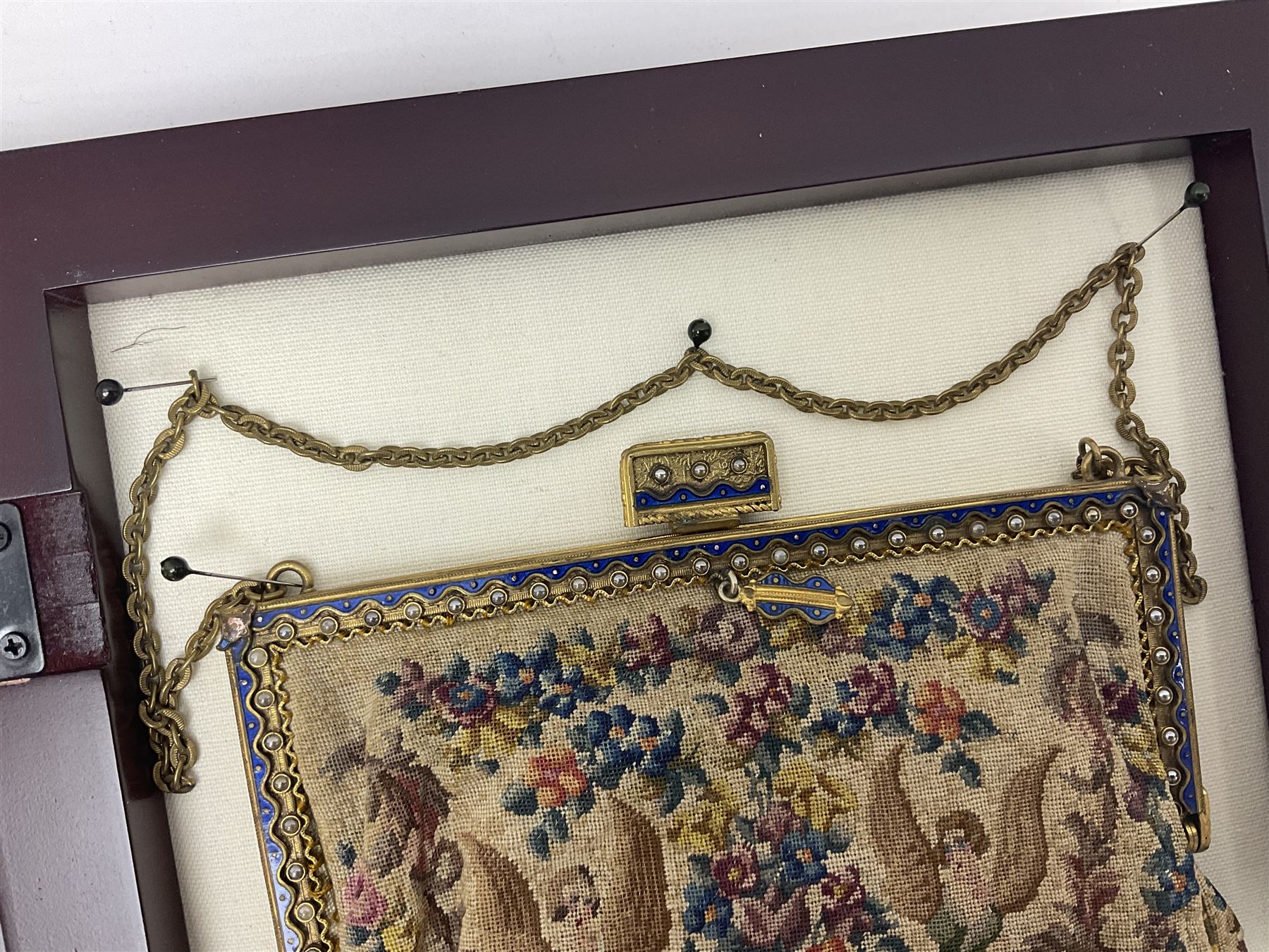 Continental petit point evening bag, with enamel and pearl details, in wooden display frame, together with a snake skin handbag and three other vintage bags