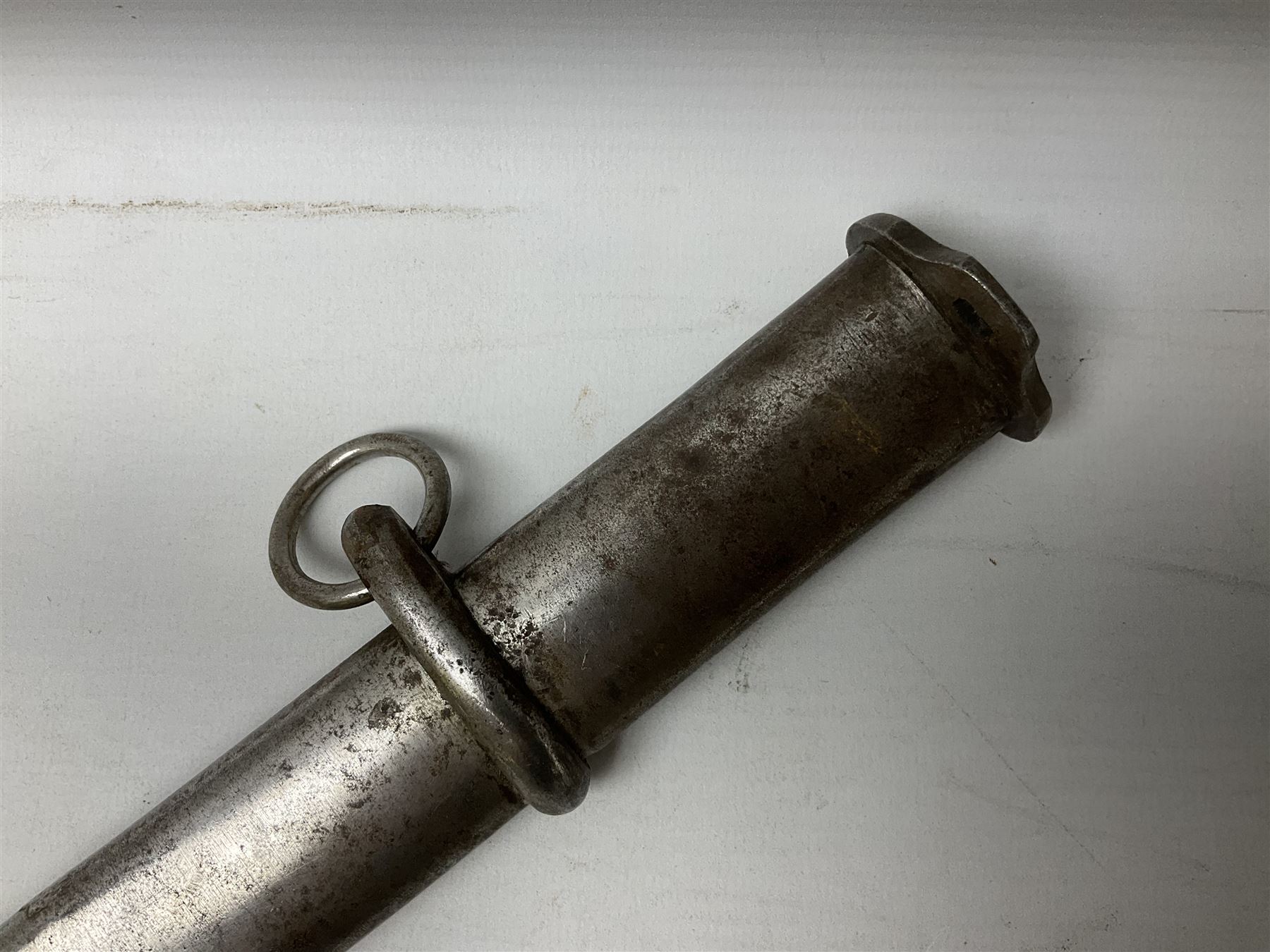 WW2 Japanese Model 1899 Type 32 'Ko' pattern cavalry sword, with 82.5cm single edged, slightly curved blade with narrow fuller, numbered 33825 to the ricasso; steel hilt with chequered backstrap and grip ears with wooden chequered grip and leather finger loop; locking action; in steel scabbard with single hanging ring L99.5cm overall