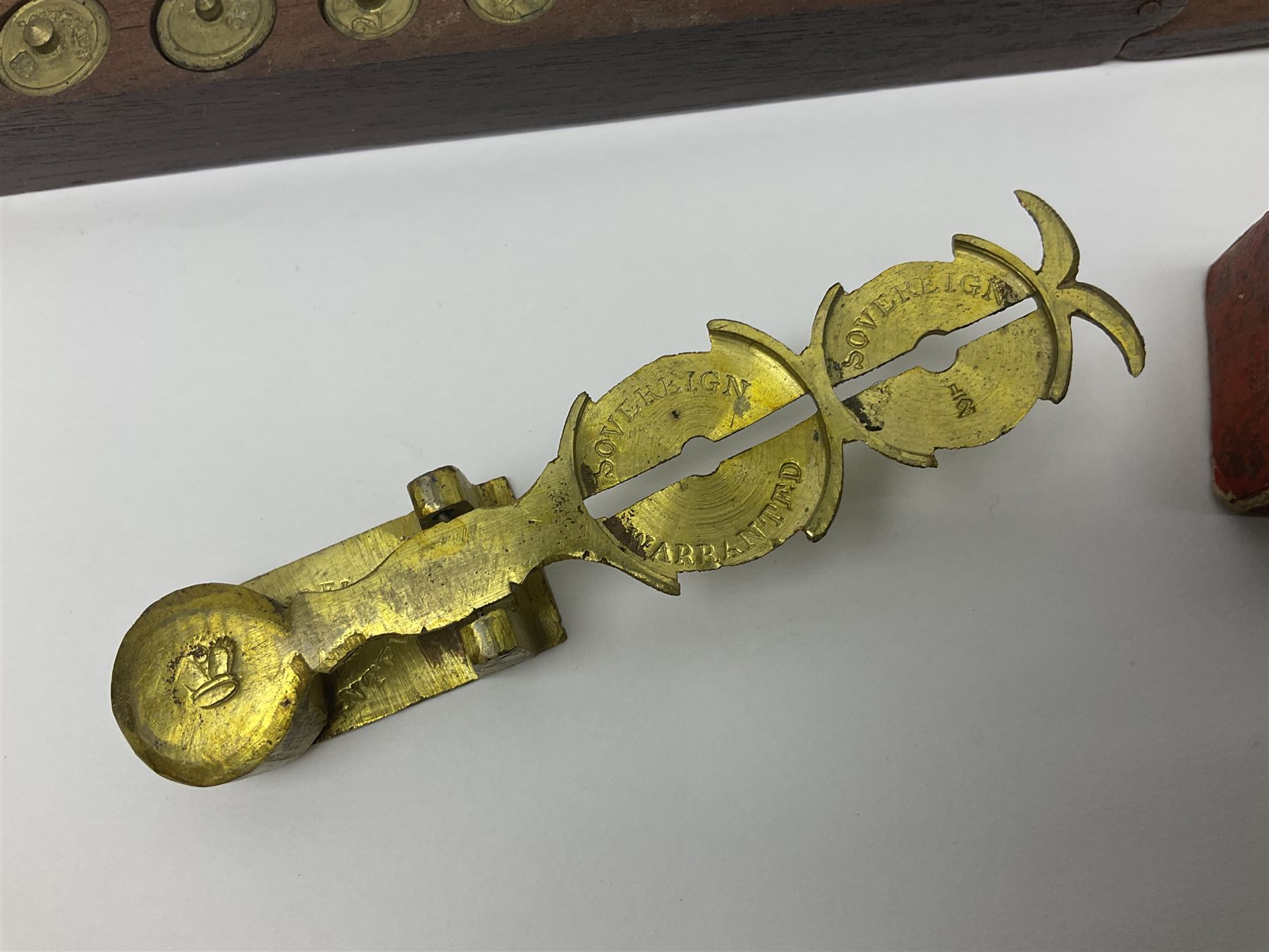Brass sovereign scales and a part set of Georgian folding sovereign scales (one weight missing)