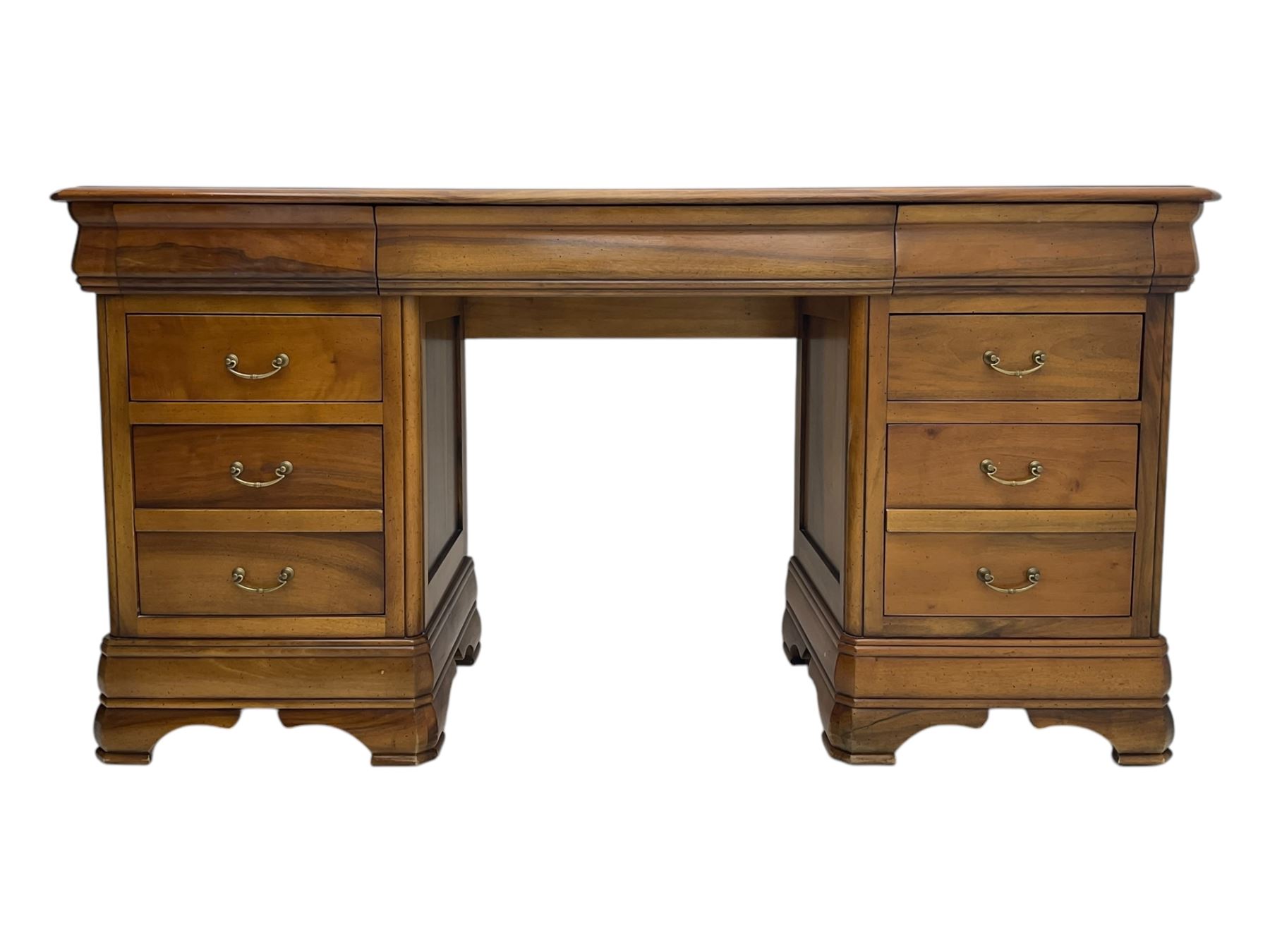 French cherry wood kneehole desk or dressing table, moulded rectangular top over twin pedestal bases each housing three drawers with brass-effect swing handles, resting on bracket feet
