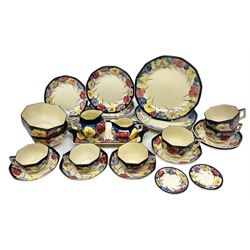 Early 20th century Art Deco Royal Doulton Pansies pattern octagonal teawares, comprising three larger teacups and saucers, three smaller teacups and saucers, open sucrier, two jugs, slop bowl, six side plates, two larger plates, two small circular dishes and one long twin handled rectangular dish, all with printed marks beneath, Rd No 597783, pattern no D4049