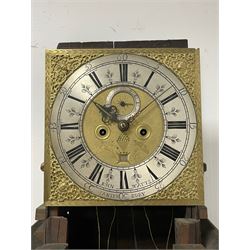 John Watts of Canterbury - early 18th century 8-day oak longcase clock, with a flat topped hood, broad cornice, dentil moulding and blind fret beneath, baluster turned pilasters with wooden capitals flanking the square hood door, trunk with recessed beaded edge and a long ogee topped door with crossbanding, plinth with applied skirting, square brass dial with matching steel hands, cast spandrels and a matted and engraved centre, date aperture, seconds ring and ring turned winding apertures, silvered chapter ring with Roman numerals, five minute Arabics, minute and quarter hour tracks, five pillar movement with a recoil anchor escapement and inside countwheel strike, sounding the hours on a bell. With weights and pendulum.