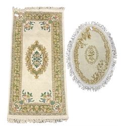 Rectangular Indian rug, floral design (183cm x 90cm), and an oval rug (118cm x 80cm)