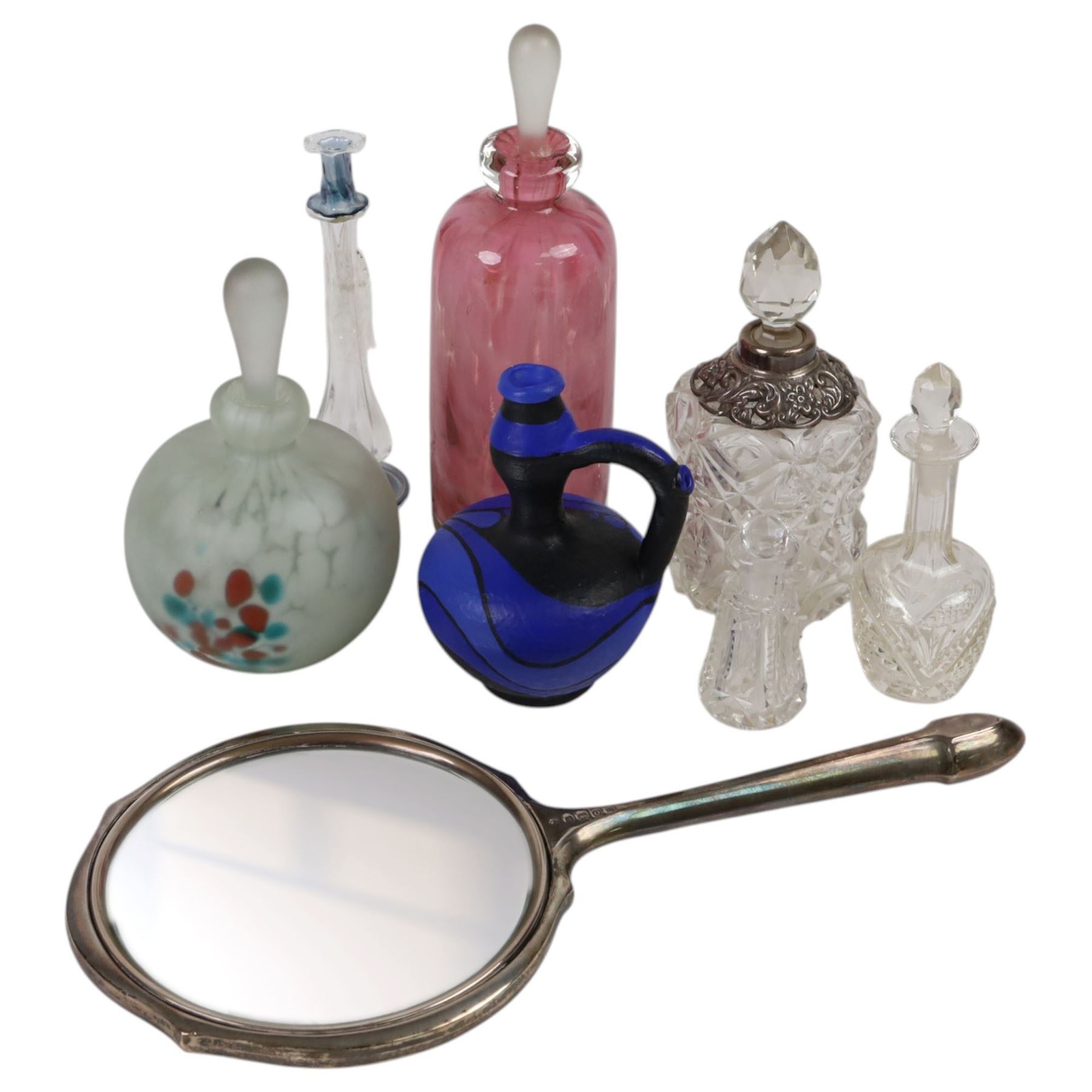 Silver mounted hand mirror, hallmarked together with silver mounted scent bottle and four other glass bottles