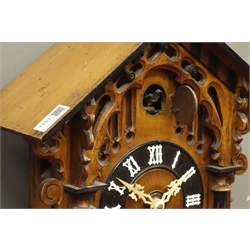  Late 19th/early 20th century Black Forest style cuckoo clock, arched architectural case, striking the hours and half on coil with two bellows, ebonised Roman chapter ring, H54cm  