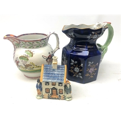  Early 19th century Pratt type money box, modelled with two figures stood outside a house, H13.5cm, Victorian pink lustre jug moulded with hunting scenes and a 19th century Masons blue ground octagonal jug painted & gilded with flowers and dragon moulded handle, impressed 'Ironstone China' (3) (mao1607)  