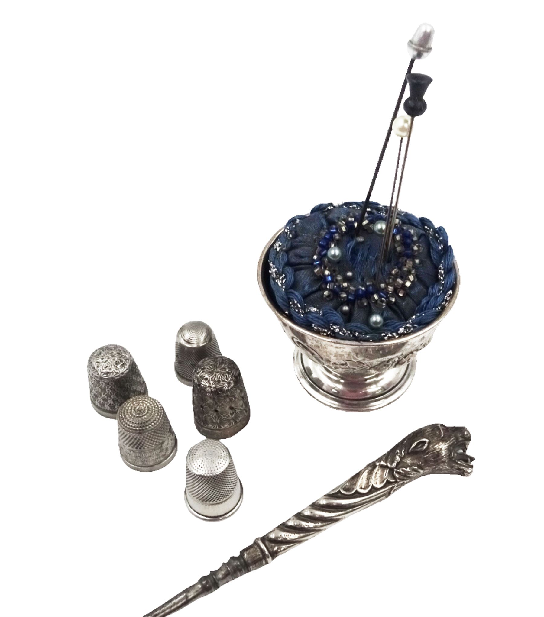 Group of silver sewing accessories, to include button hook, with silver leopard's head handle, hallmarks worn and indistinct, an Edwardian silver pin cushion, with embossed rose decoration and removable beaded pin cushion, hallmarked Charles Boyton & Son Ltd, London 1905 and five silver thimbles, including one continental silver example, all stamped or hallmarked 