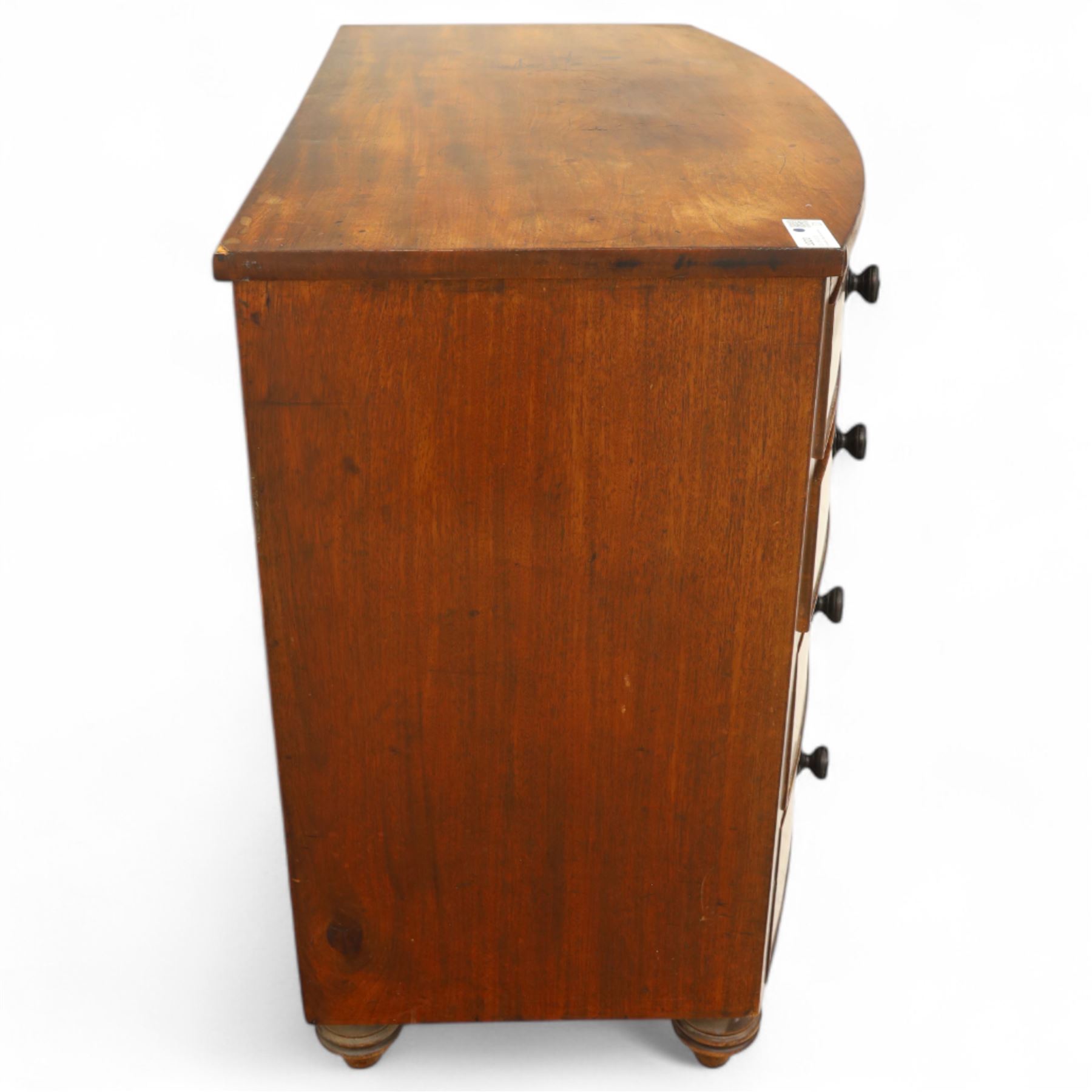 Mid-19th century mahogany bow front chest, fitted with four graduating drawers, turned ebonised handles, bun feet