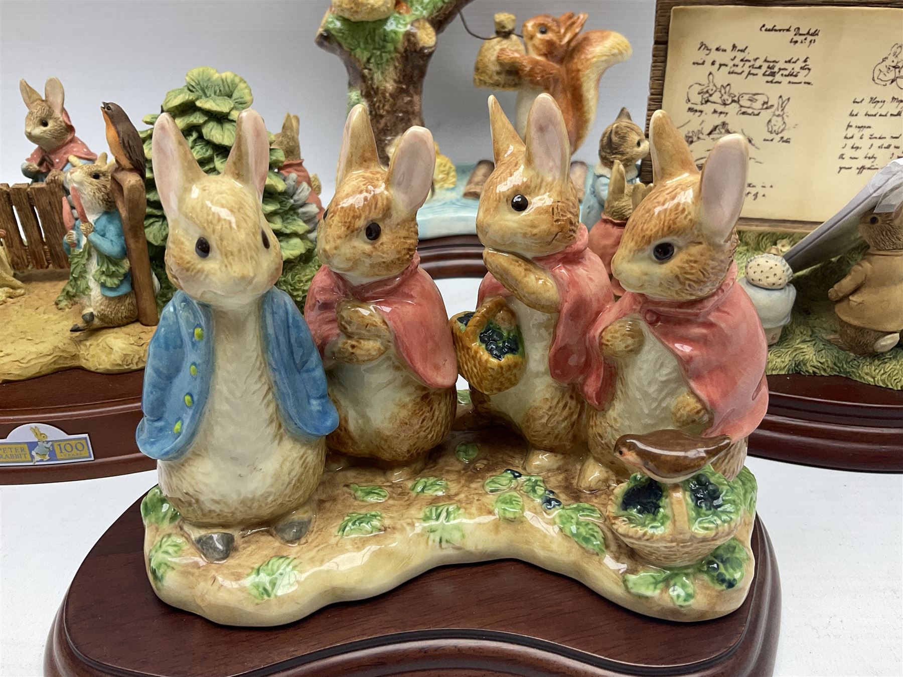 Four Border Fine Arts Beatrix Potter figures, comprising Tableau created to commemorate the Millenium together with a Border Fine Arts Limited Edition no 669814, The Tale of Peter Rabbit Tablet A1306, Four Little Rabbits A2442 and Sailing Home A2443