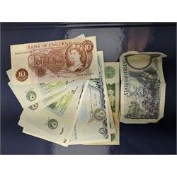 Great British and World banknotes, including two Bank of England Gill five pounds 'SA79432020' and 'SA79432021' various Somerset one pounds etc, Reserve Bank of New Zealand fifty dollars, various The States of Jersey one pounds, Singapore ten dollars etc, housed in a ring binder folder