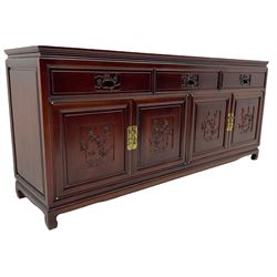 Hardwood sideboard, three drawers over cupboards, the doors relief carved with flowers are birds 