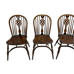 Set four oak Windsor chairs, hoop and stick back with pierced splat, dished seats on turned supports with crinoline stretcher