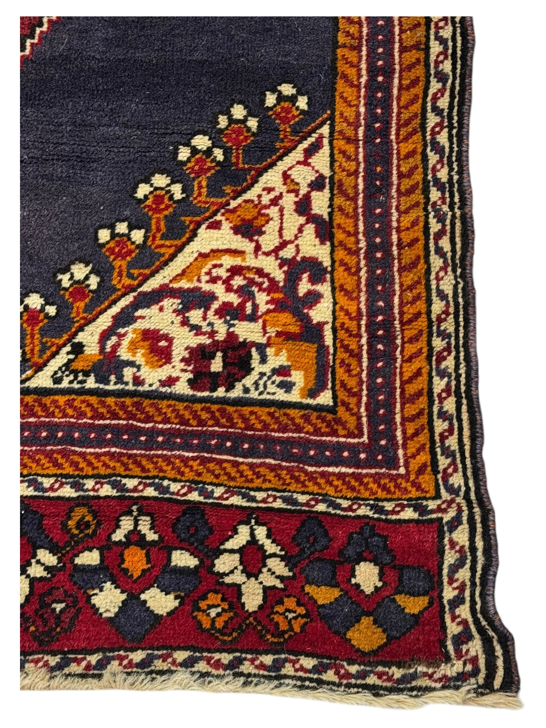 West Persian Hamadan rug, hand knotted, central medallion bordered by geometric and intricate floral motifs, displaying red cream and indigo colours with an orange coloured border  